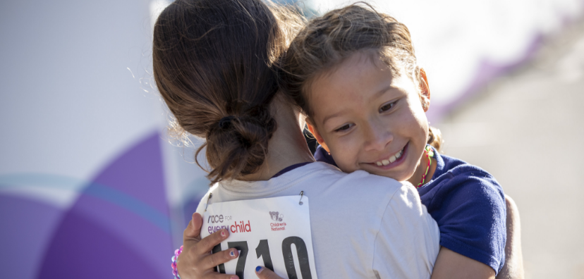 Two children hugging at last year's Race
