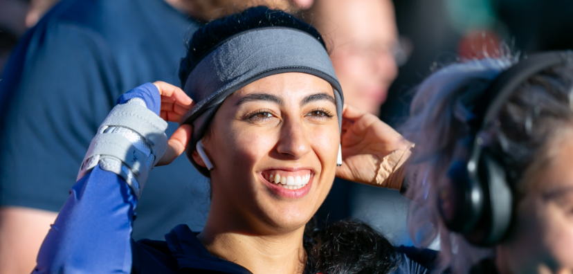 Woman wearing a headband and smiling off into the distance at last year's Race