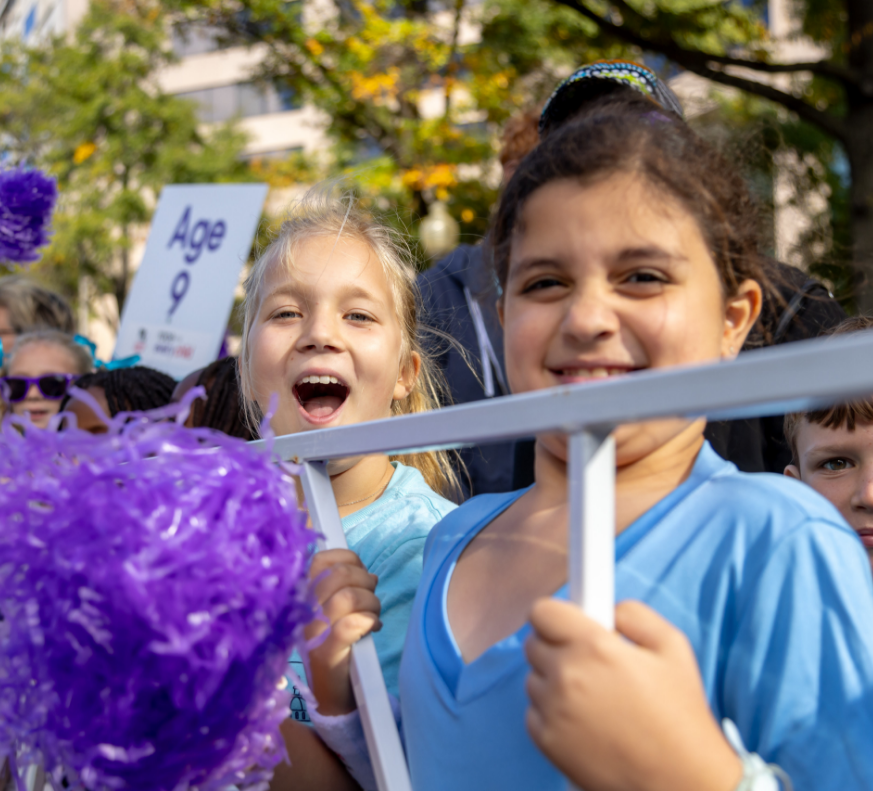 Young girl with poms poms smiling